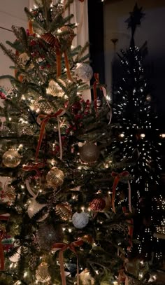 a decorated christmas tree with gold and silver ornaments