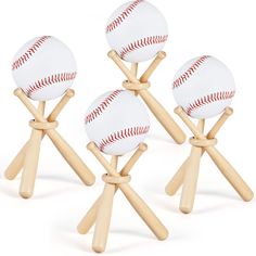 four baseballs on wooden sticks with white background