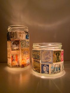 two glass jars with stamps on them sitting next to each other