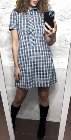 It's a Vintage 70s blue plaid mini shirt dress. Half buttoned. Collared. Short sleeved. Not stretchy fabric. Brand:  Size: XS. Material: Cotton blend. Great vintage condition. Model's height: 5'8 / 178 cm / Size S. MEASUREMENTS: Shoulders: 14 inch / 35 cm. Sleeve: 8 inch / 20 cm. Bust doubled: 32 inch / 84 cm. Waist doubled: 30 inch / 78 cm. Length: 35 inch / 88 cm. Worldwide shipping. Shipping takes to: USA 7-14 days.  EU 4-7 days. Others countries 7-14 days. Blue Mini-length Plaid Dress For Spring, Blue Knee-length Plaid Summer Dress, Casual Button-up Plaid Dress, Plaid Cotton Button-up Dress, Plaid Cotton Button-up Shirt Dress, Blue Plaid Shirt, Preppy Dresses, Plaid Dress Shirt, Retro Vintage Dresses