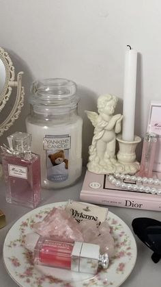 a table topped with pink and white items on top of a counter next to a mirror