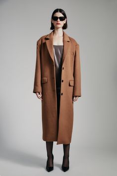 Intentional warmth. The Structured Oversized Camel Coat features a contemporary boxy fit in a longline shape with a notched lapel, shoulder pads, back vent, functional pockets and a three-button front.SIZING: Boxy fit. AU: Model wears a size 8 / US: Model wears a size 4.FABRICATION: Main: 52% polyester, 39% viscose, 9% elastane - Single breasted - Shoulder pads - Longline Oversized Camel Coat, Corsets Fashion, Camel Wool Coat, Mum Jeans, Camel Style, Day To Night Dresses, White Cocktail Dress, Essential Dress, Jumpsuit Jacket