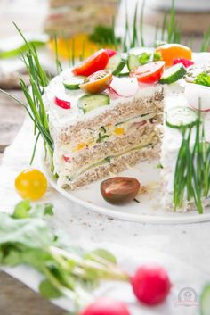 there is a cake that has been cut in half on a plate with other food items around it