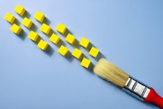 A Brush and yellow cubes like paint. Creative modern art. royalty free stock photos Modern Art, Paint, Yellow