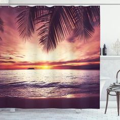 a shower curtain with a sunset and palm trees on the beach