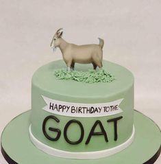 a birthday cake with a goat on top