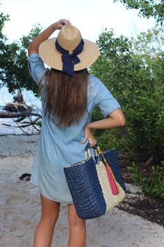 This over-sized straw tote is your go-to carryall for Saturday morning farmer's markets, family beach days or completing the perfect linen suit. Topped with ornamental wrapped handles and suede tassels, it is completed by a classic linen interior lining. This navy and natural structured tote feels modern and bohemian at once. Content:- Paper Straw- Linen Lining- Suede- Imported Size:- Width: 22" - Height: 12"- Depth: 6"- Handle Drop: 3.5" Rectangular Beach Bag With Tassels For Summer, Bohemian Beach Bag With Leather Handles For Summer, Bohemian Summer Beach Bag With Leather Handles, Rectangular Summer Beach Bag With Tassels, Summer Beach Tote Bag, Straw Beach Bag For Summer Outings, Blue Straw Bag With Leather Handles For Summer, Chic Blue Handwoven Straw Bag, Woven Jute Straw Bag For Summer Outings