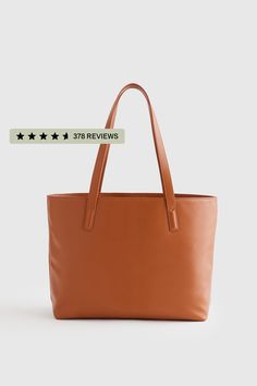 This well designed, full-size, beautiful Italian leather tote bag is perfect for your everyday needs. Includes all the inner organization to keep you on track throughout the day including a 13" laptop slip, iPhone pocket, zipper pocket, plus several other pockets and a hook for your keys. Your go-to everyday tote, no doubt.  | Quince | Women's Classic Italian Leather Tote Bag in Cognac Versatile Shoulder Tote Bag With Interior Card Slots, Versatile Brown Laptop Bag For Everyday Use, Modern Large Capacity Bags, Modern Large Capacity Bag, Large Modern Satchel For Daily Use, Trendy Bags With Interior Card Slots For Everyday Use, Modern Large Satchel For Daily Use, Trendy Everyday Bags With Interior Card Slots, Shopping Tote Shoulder Bag With Interior Card Slots