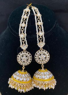 Kundan Earrings ** Gold Plated Kundan Jhumka Earrings with hair chains ** Hook at the end of the chain to put it on your hair. (Check out the picture) ** Statement Earrings. ** With this Ear/hair chain, the earrings are supported comfortably.  ** Free shipping over $35 Pair them up with Lehanga or saree to give a glamorous party look. Free shipping over $35 Feel free to reach out to us with any questions. Check out our other listings at: https://www.etsy.com/shop/mdbeadworks?ref=seller-platform- Dangle Latkan Jhumkas For Weddings, Dangle Jhumkas For Wedding And Navratri, Wedding Dangle Jhumkas For Navratri, Heavy Dangle Jhumkas For Diwali, Traditional Drop Jhumkas With Stone Work, Traditional Jhumkas With Stone Work, Traditional Cutdana Dangle Jhumkas, Traditional Cutdana Jhumkas Dangle, Traditional Stone Work Jhumkas