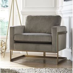 a living room with a gray chair and white rug