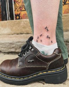 a person's foot with small black stars on it