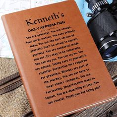 a book with writing on it sitting next to a pair of binoculars