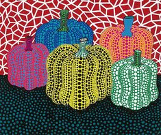 four pumpkins are painted in different colors on a red and blue background with circles