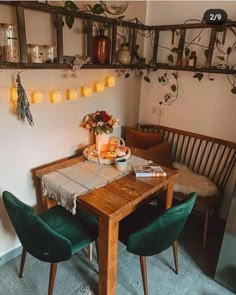 a wooden table topped with plates of food next to a green chair and wall mounted planter