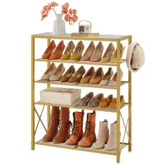 a gold shoe rack with several pairs of shoes on it and a vase filled with flowers