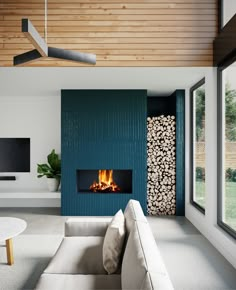 a living room filled with furniture and a fire place next to a wall mounted tv