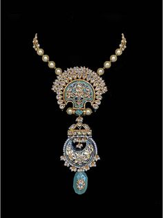 Experience the captivating contrast of blue meenakari work and an ornate barium drop in this stunning piece, bringing it to life with irresistible charm. Pair this necklace with your outfit for a classy and elegant look that is sure to turn heads. Finish: Gold Finish Material: Brass, Kundan, Barium, Pearls Color: Gold, White, Blue Size: One Size Closure Type: Box Lock Box Contains: 1 Necklace Blue Meenakari Jewellery, Ornate Meenakari Pendant Jewelry, Ceremonial Meenakari Pendant Jewelry, Elegant Kundan Necklace With Peacock Pendant, Elegant Blue Kundan Necklace With Intricate Design, Ornate Kundan Necklace With Meenakari For Ceremonial Occasions, Formal Fusion Style Cutdana Necklace, Kundan Pendant Jewelry With Peacock Design, Ornate Meenakari Pendant Necklace