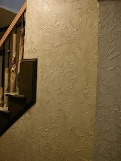 the stairs are lined with baseball bats in this home's stairwell area, which is painted white