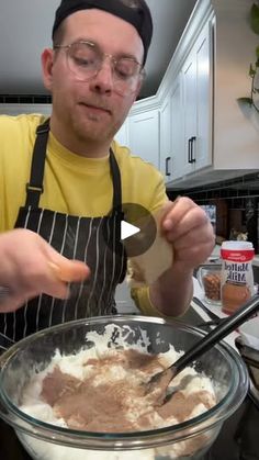 a man in an apron mixing food into a bowl