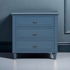 a blue chest of drawers in a room