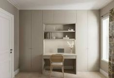 an empty room with a desk, chair and bookshelf next to a window