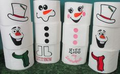 several toilet paper rolls decorated like snowmen with faces and words on them, all painted in different colors