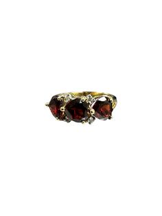 She loves you, she loves you, she loves you! Three sparkling deep red heart shaped garnets accented by four diamonds make this the perfect ring to proclaim your love.  This vintage ring is destined to be loved and adored! Metal:  14 karat yellow gold Gemstones:  Three heart shaped garnets (they are very "fat" hearts so they almost look like pear shapes) measuring approximately 5.50mm x 5.90mm and are considered to be dark red in hue. Accenting the ring are four full cut round brilliant diamonds having a combined estimated weight of 0.06 carats.  Ring Size:  7-1/4 INTERNATIONAL BUYERS--PLEASE NOTE! Customs and import taxes Buyers are responsible for any customs and import taxes that may apply. I'm not responsible for delays due to customs. Website:  www.gallunfinejewelry.com FaceBook:  http Red Gemstone Jewelry, Pear Shapes, Garnet And Diamond Ring, She Loves You, Red Gemstones, To Be Loved, Vintage Ring, She Loves, Perfect Ring