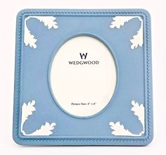 a blue and white photo frame with the word weddwood written in black on it