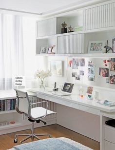 a white desk and chair in a room with bookshelves on the wall above it