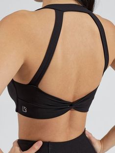 Features: Twist front detailing Back twist detailing V-neckline Halter detail Removable bust pads Details: Fabric: Butter (Nylon/Spandex) Light Support Level Description: The Twisted Sports Bra is a shortline sports bra with V-shaped neckline that’s sure to highlight all your best features. It features a front and back twist detail and a halter strap detail for a chic look. It is made with our Butter fabric for a soft, buttery feel with great flexibility. Black Cross Back Activewear With Built-in Padding, High Stretch Padded Sports Bra For Workout, Sporty Fitted Crop Top With Cross Back, Sports Crop Top With Cross Back And Stretch, Sports Crop Top With Stretch And Cross Back, Sports Stretch Crop Top With Cross Back, Athleisure Sports Crop Top With Cross Back, Sports Crop Top With Built-in Bra And 4-way Stretch, Fitted Padded Bra For Gym