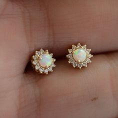 Super cute opal stud earrings featuring a pavé halo! Looks stunning as a first or second hole piercing.  - - -  D E T A I L S - - -  * Made of 925 Sterling Silver * We use a THICK plating of 14k Gold or Rhodium * Nickel-free & Hypoallergenic (safe for sensitive ears!) * Sold as a pair  * 7mm Diameter * Push-back closure ✻ Earrings on Model ✻ Bezel Opal Studs --> https://www.etsy.com/listing/692672584/opal-stud-earrings-small-studs?click_key=46e17fce4fac05d0b89f4ca34b25042ca6b6303e%3A692672584&click_sum=ac9c35dd&ga_search_query=opal%2Bstuds&ref=shop_items_search_4&pro=1&frs=1&sts=1 Tiny Opal Studs --> https://www.etsy.com/listing/869783588/opal-earrings-tiny-opal-stud-earrings?click_key=fed4aa04fafb46df9f585b2681d142b8076bf172%3A869783588&click_sum=3fd9b6ca&ga_search_query=opal%2Bstuds&ref= Single Opal Earring As A Gift, Earings Piercings Opal, Yellow Gold Opal Earrings For Gifts, Opal Stud Earring, Dainty Studs, Tiny Studs, Opal Earrings Stud, Tiny Earrings, Opal Studs