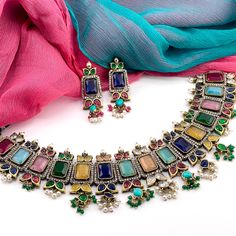 This beautiful necklace features a matte golden finish and a combination of colorful stones and CZ. Perfect for any occasion, this stunning necklace is sure to be admired. Available in multiple color choices: - Multicolor / Rainbow - Ruby Red - Emerald Green Luxury Statement Emerald Necklaces, Luxury Emerald Kundan Necklace For Festivals, Luxury Multicolor Emerald Gemstone Necklace, Multicolor Gemstone Jewelry Sets For Weddings, Elegant Multicolor Necklace For Festive Season, Fusion Style Multicolor Bridal Necklace For Party, Multicolor Fusion Bridal Necklace For Party, Multicolor Gemstone Temple Jewelry Sets, Multicolor Gemstone Jewelry Sets For Celebration