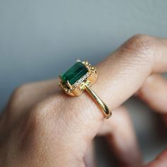 Read about our payment plans before proceeding.The Isis Emerald Scroll Diamond ring is an exquisite piece. Inspired by the details on architectural buildings in NYC, this ring features a stunning natural emerald framed by two baguette diamonds and round diamonds. Made for a true goddess with a touch of vintage vibe. Available in 14K solid yellow gold, white gold, and rose gold. 14K solid gold Natural 9*7mm emerald. Approx. 2.6ct. Comes with a certificate Natural baguette diamonds. Approx. 0.04ct Luxury 14k Gold Emerald Wedding Ring, Luxury Gold Emerald Ring For Wedding, Yellow Gold Emerald Ring With Intricate Design, Luxury Gold Emerald Ring With Halo Setting, Elegant Yellow Gold Emerald Ring With Intricate Design, Timeless Hallmarked Emerald Ring For Wedding, Elegant Gold Emerald Promise Ring, Elegant Gold Emerald Ring For Promise, Luxury Gold Emerald Ring For Promise