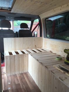 the interior of a van with wooden drawers