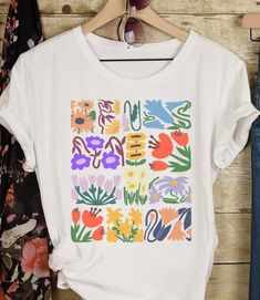 Matisse Boho Flower Shirt Wildflowers Nature Tshirt Floral T Shirt Botanical Art Nouveau Deco Gift for her  This classic Bella canvas unisex jersey short sleeve tee fits like a well-loved favorite. Soft cotton and quality print will make you fall in love with it over and over again. These t-shirts have-ribbed knit collars to bolster shaping. The shoulders have taping for better fit over time. Dual side seams hold the garment's shape for longer.  S H I P P I N G IMPORTANT: Please note that we ship to the address provided at check out. If you are ordering this as a gift and wish to have it shipped elsewhere, please enter the correct address at check out. If an incorrect shipping address was given and the gift is returned back to our shop, the customer is responsible for paying the re-shippin Cheap Oversized Floral Print T-shirt, Tabitha Swatosh Flower Shirt, Patterned Floral Print Cotton T-shirt, Artistic Multicolor Floral Print Tops, Artistic Floral Print Tops For Spring, Multicolor Floral Print T-shirt For Summer, Spring Patterned Tops With Plant Print, White Shirt With Abstract Print For Spring, Artsy Printed Summer Tops