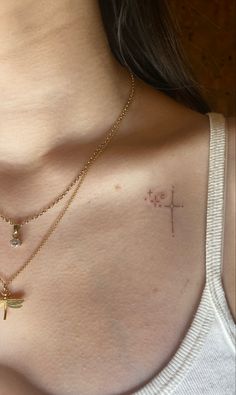 a woman with a cross tattoo on her chest