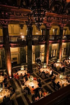 an overhead view of a dining hall with tables and chandeliers in the center