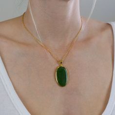 The darker greens in this Nephrite Jade necklace give you more freedom to express yourself. It's a simple neutral gemstone necklace that will brighten your day when paired with other gems. It's all about harmonizing energy with this old, precious crystal necklace. Stone Origin: New Zealand Measures Approximately: 39 x 25 mm Materials: Hand Crafted 925 Polished Sterling Silver with 14k Yellow Gold Vermeil finish and Gold Filled Chain Please Note: If you would like to purchase a different chain pl Green Oval Pendant Necklace For Spiritual Style, Green Oval Pendant Necklace Spiritual Style, Spiritual Green Oval Pendant Necklace, Green Oval Necklace With Large Stone, Oval Green Necklace With Large Stone, Jade Oval Pendant Necklace With Natural Stones, Green Oval Pendant Necklace With Adjustable Chain, Jade Necklace With Oval Pendant And Natural Stones, Green Necklace With Oval Pendant And Natural Stones