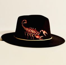 This black felt Fedora hat is a one of a kind, hand burned and hand painted original design. It would make a great hat for anyone who loves scorpions, spiders and other crawly things. Black Handmade Artistic Hat, Handmade Black Felt Hat With Flat Brim, Handmade Artistic Black Hat, Custom Handmade Black Felt Hat, Black Hand Painted Hat With Curved Brim, Hand Painted Black Hat With Curved Brim, Black Hand-painted Hat With Curved Brim, Handmade Black Felt Hat For Festival, Custom Black Handmade Felt Hat