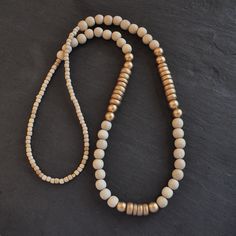 With a mix of whitewash and gold wood beads and in an easy pull-over-the-head style, this limited edition wood bead necklace is sure to dress up...well, anything! 8mm whitewashed and gold painted wooden beads gold-plated crimp with bead closure 28 inches long all Libby & Smee necklaces come packaged in a clear resealing bag for storage Gold Beaded Necklace With Wooden Beads, Elegant Gold Beaded Necklaces With Wooden Beads, Adjustable Gold Necklace With Wooden Beads, Vintage Gold Beaded Necklace With Wooden Beads, Wood Bead Necklace Gold, Wood Bead Necklace, Gold Wood, Gold Paint, Wooden Beads