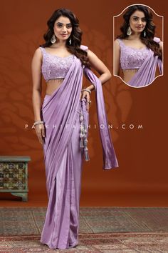 Embrace elegance in this lilac pre-pleated saree, designed for the modern woman. The ready-to-drape soft silk saree offers a perfect blend of tradition and convenience, while the blouse shines with intricate stone, sequin embroidery, cutdana, and handwork. Perfect for weddings or festive events, this saree ensures you stand out with effortless grace. Elegant Purple Pre-draped Saree, Purple Floor-length Pre-draped Saree For Reception, Elegant Semi-stitched Lavender Set, Purple Pre-draped Saree With Cutdana For Reception, Fitted Lavender Blouse Piece For Festive Occasion, Festive Fitted Lavender Blouse Piece, Purple Georgette Pre-draped Saree, Fitted Lavender Saree With Zari Work, Elegant Lavender Saree With Cutdana