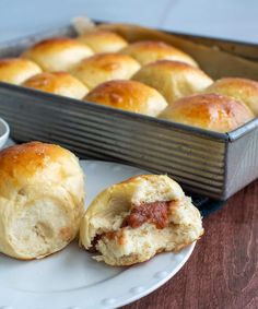 a plate that has some rolls on it and a bowl of dipping sauce next to it