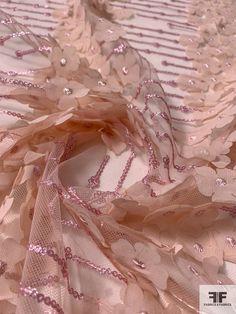 Beds of pink flowers in perfect rows are pretty as can be on this blush and pink fine netting with 3D floral chiffon appliqués and sequins detailing designer fashion fabric. SKU: 12322 Content: Polyester Color: Blush / Pink Width: 50 inches This fabric is a last cut and no longer in production. Once sold out, we are unable to get more. Embellished Tulle Fabric For Spring Wedding, Pink Floral Embroidered Tulle Fabric For Party, Pink Tulle Fabric With Floral Embroidery For Party, Pink Tulle Fabric With Appliques For Party, Pink Party Tulle Fabric With Appliques, Pink Tulle Fabric For Summer Wedding, Party Tulle Fabric With Floral Embroidery, Elegant Pink Fabric For Party, Elegant Pink Sequin Fabric For Summer