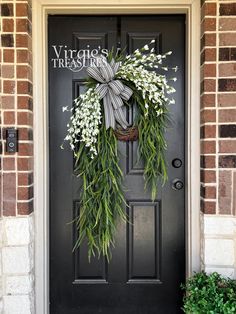 Blossom your surroundings with beautiful blooms. This wreath features foam leaves and paper blooms sporting a solid white color with saw grass stems cascading around the grapevine wreath. Add this lovely wreath to create a unique, one-of-a-kind statement!    Details: Dimensions (Varies Upon Shaping): 35"x22" Plant Type: Flower Bush Material: Foam, Paper & Plastic Color: White & Green Care & Safety: Indoor Use Only Quantity: 1 **Be sure to fluff wreath when you take it out of the box to achieve r Elegant Door Wreaths, Contemporary Wreaths For Front Door, Front Door Decor Plants, Asymmetrical Porch Decor, Wreath With Storm Door, Double Wreath Ideas, Modern Front Door Wreath, Modern Door Wreath, Outside Home Decor