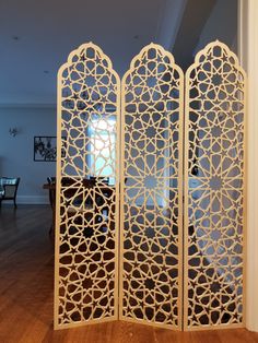 the room divider is made out of wood and has an intricate design on it