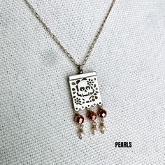 This exquisite Joyeria Plata necklace, featuring a unique Papel Picado pendant, is a masterpiece of Mexican craftsmanship. Handcrafted with meticulous attention to detail, it echoes the rich cultural heritage of Artesanias Mexicanas. The delicate Papel Picado design, a traditional Mexican folk art, is beautifully rendered in silver, making this Taxco necklace a captivating piece of Joyeria Mexicana. Adorned with intricate patterns, it captures the vibrant spirit of celebrations like Cinco de Mayo and Dia de los Muertos. This Mexican silver necklace is more than just an accessory; it's a symbol of Mexican tradition and artistry. With its fine craftsmanship and unique design, it stands out as a stunning representation of Taxco's renowned silverwork. The Papel Picado pendant adds a touch of e Sterling Silver Dangle Necklace For Festivals, Sterling Silver Necklace With Large Pendant For Festival, Elegant Copper Dangle Necklaces, Elegant Nickel-free Necklace With Rectangular Pendant, Ornate Pendant Necklace For Celebration, Handmade Metal Necklace With Rectangular Pendant, Bohemian Silver Necklace With Copper, Bohemian Silver Necklace In Copper, Traditional Silver Necklace With Square Pendant