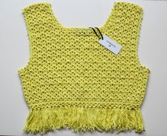 Crochet yellow crop top with tassels festival beach style Available in UK 12 to buy now. See below on how to preorder if you would like a different size: We're a UK brand that specialise in handmade clothing. All our items are created by Anne Lee, with help from Amy. Our styles reflect hippie/bohemian fashion and we like to mix bright colours and patterns to create one of a kind items.  Every item is slightly different and unique, all handmade personally for you with love. This means we only sell in limited quantities and not every size/style is listed. If you are interested in an item and would like to pre-order this in your size, please send us a message. Please check out our other items x Fringe Tops For Spring Music Festival, Spring Fringe Tops For Music Festival, Spring Music Festival Top With Fringe, Spring Festival Sleeveless Crop Top, Yellow Bohemian Crochet Top For Vacation, Yellow Crochet Top For Spring And Summer, Casual Spring Crochet Top With Tassels, Casual Yellow Crochet Top For Summer, Casual Yellow Crochet Top For Vacation