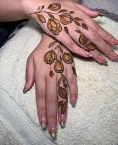 two hands with henna designs on them