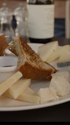 a white plate topped with cheese and bread