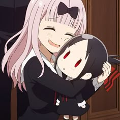 two anime characters hugging each other in front of a door